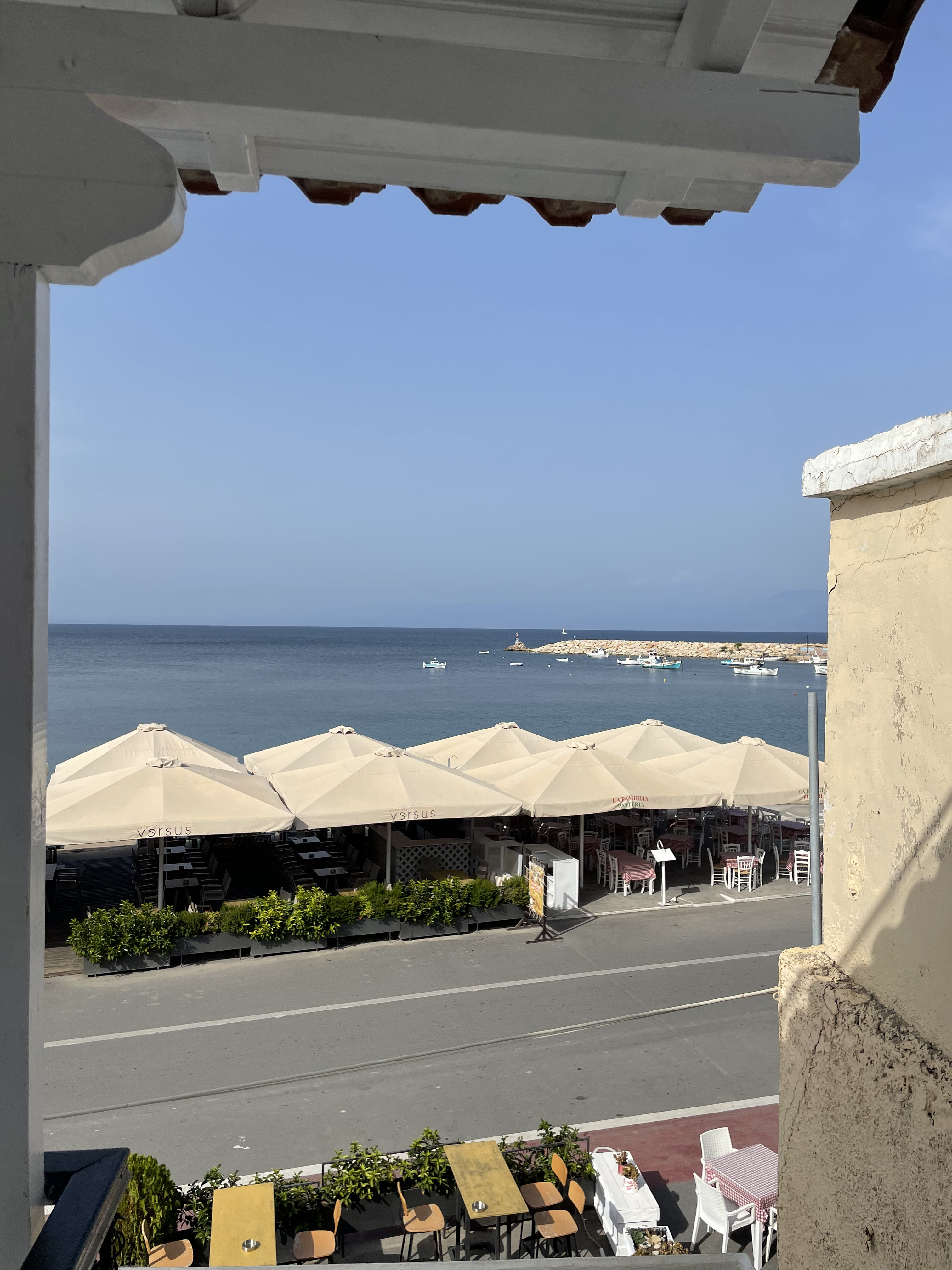 Harbour and sea framed through the white archway