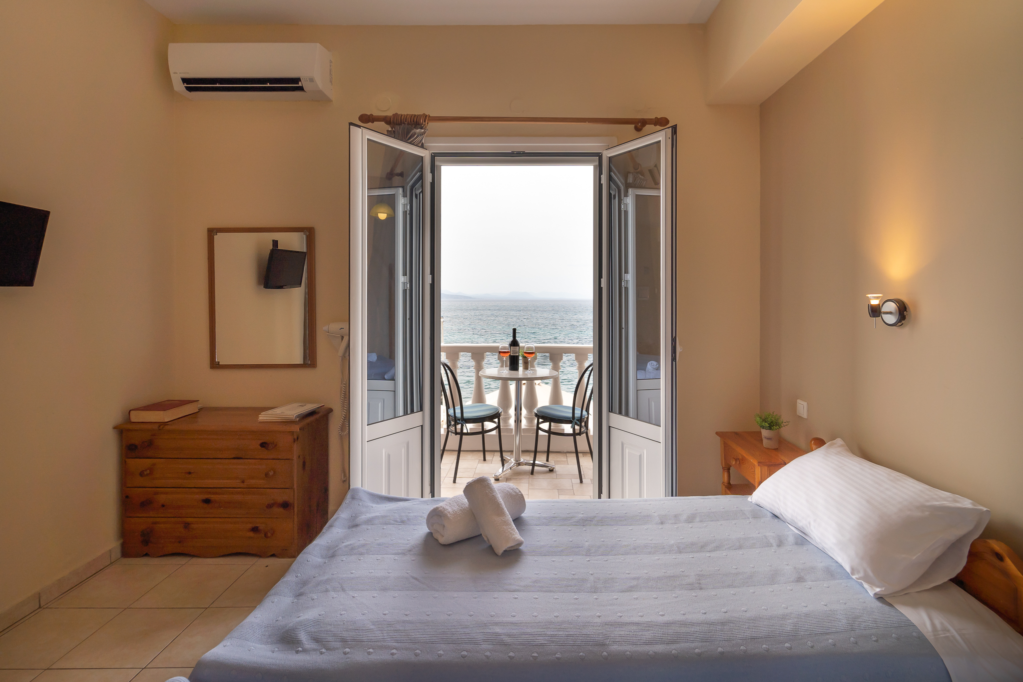Double room with balcony doors open to the sea