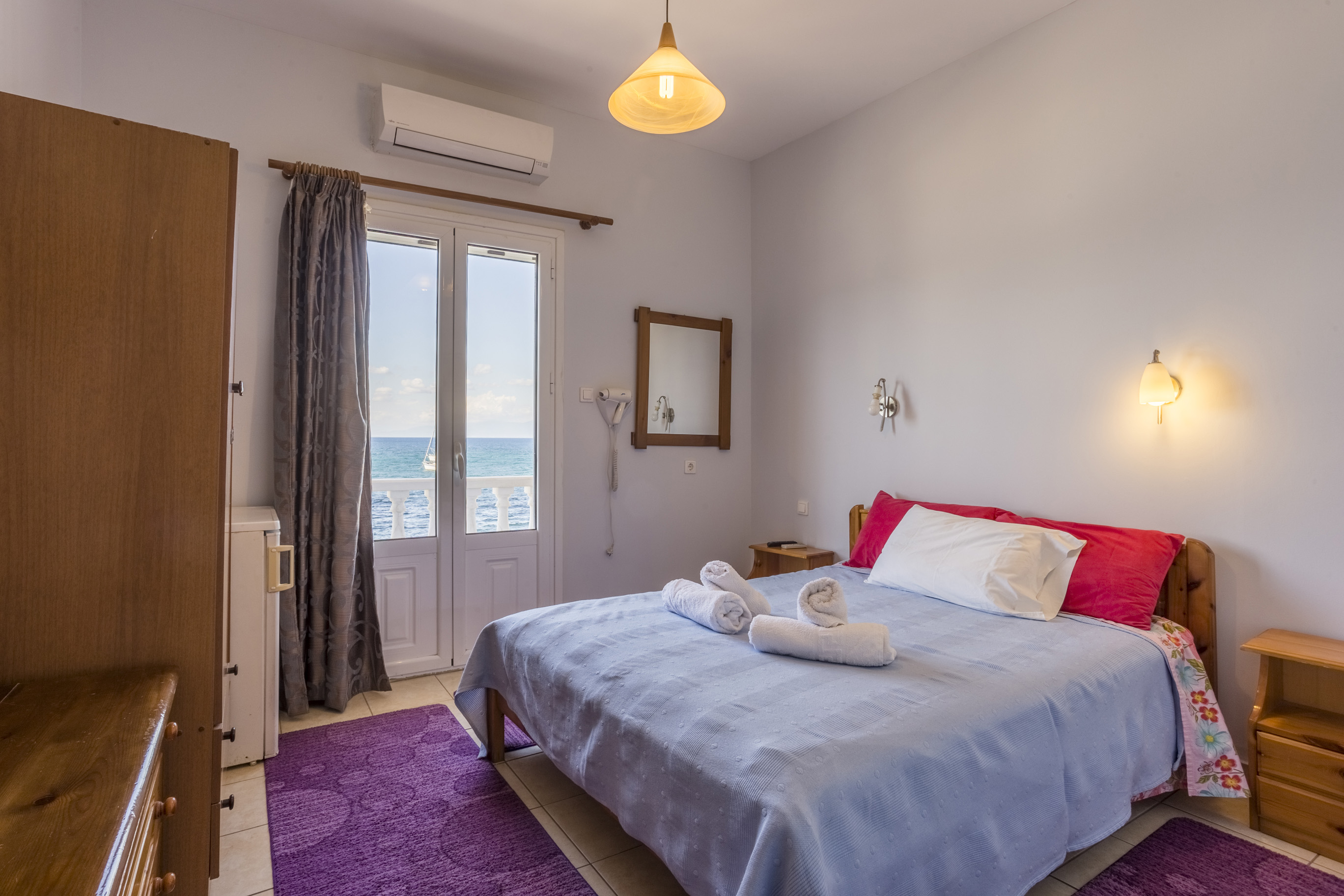 Double room with sea view and red cushions